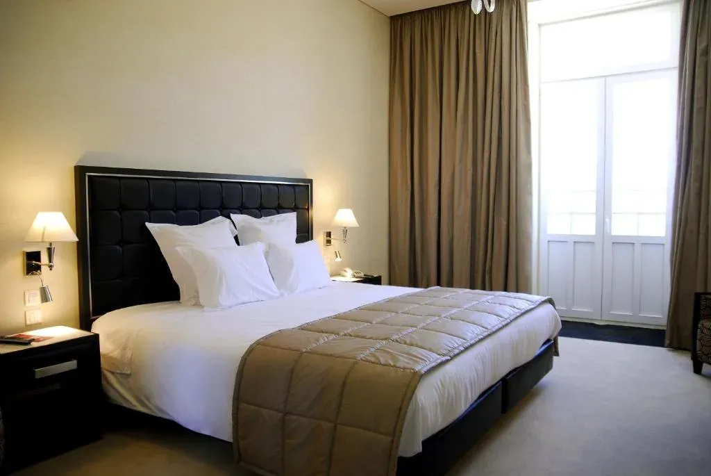 Quarto do Curia Palace Hotel, decoração clássica e confortável